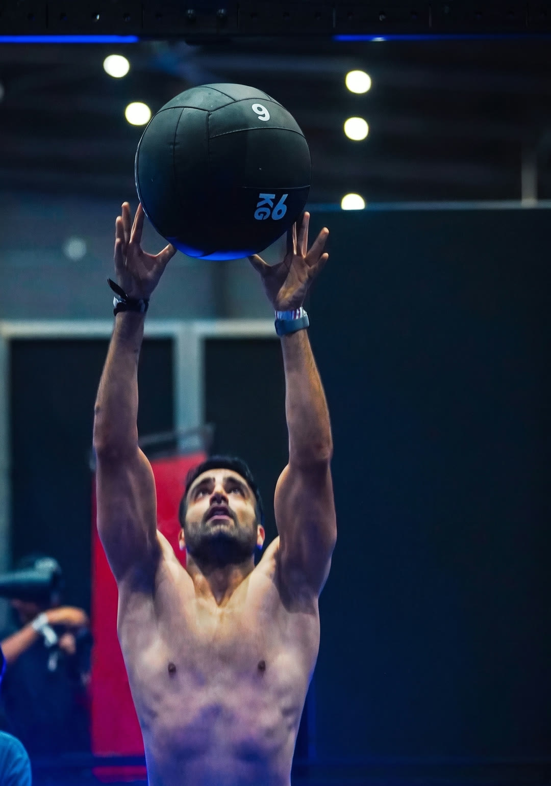 An athlete on the wall balls station at a HYROX race.